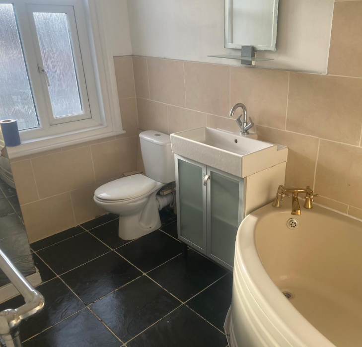 The same bathroom restored to pristine condition after cleaning and restoration